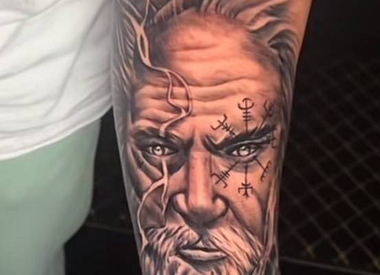 Bearded portrait tattoo on a forearm
