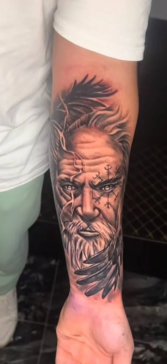 Bearded portrait tattoo on a forearm