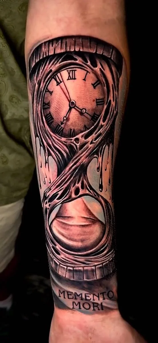 Clock motif with flowing details on a forearm